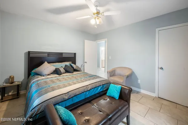 a bedroom with bed and window