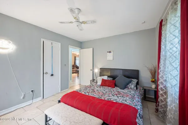 a bedroom with a bed and a chandelier