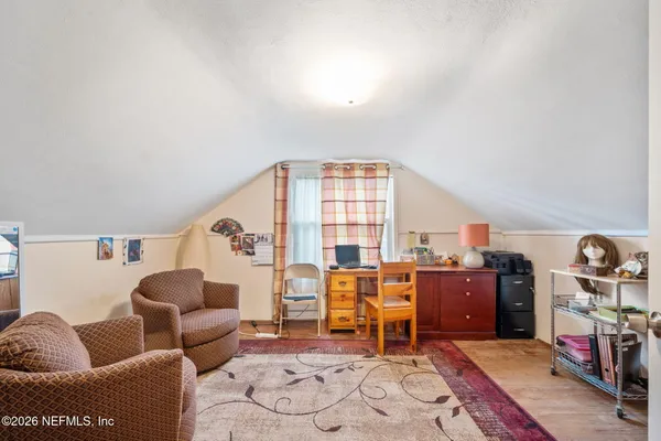 a living room with furniture a rug and a large window