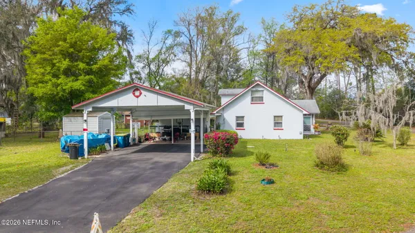 a view of a house with a yard patio and slide