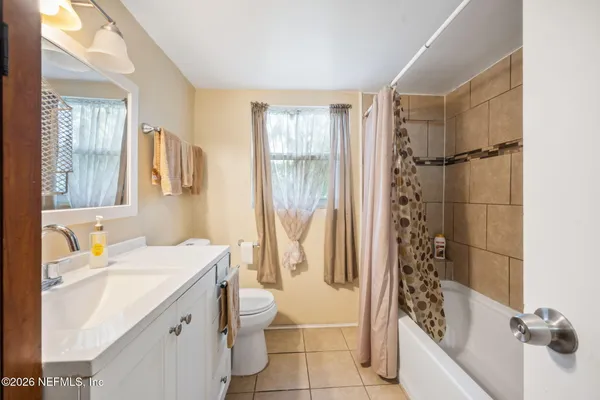 a bathroom with a sink toilet tub and shower