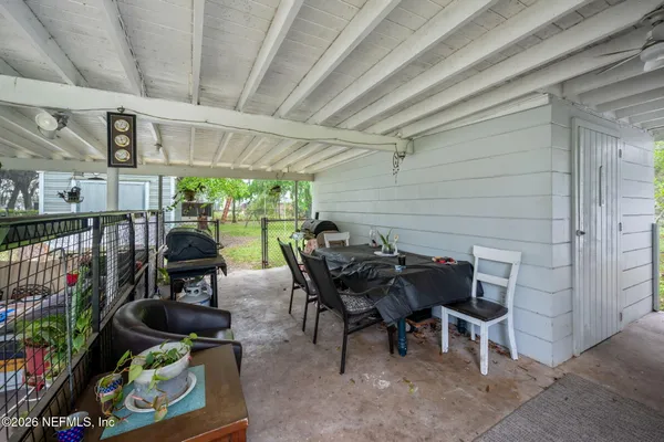a view of a patio with table and chairs potted plants with wooden floor