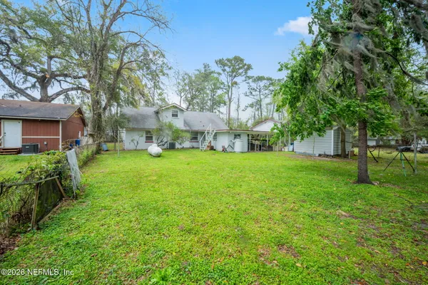 a view of house with backyard