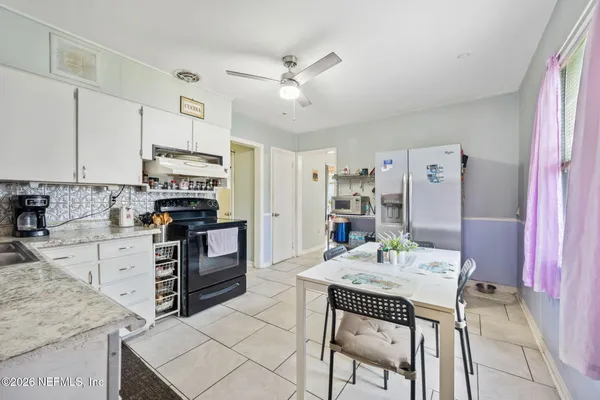 a kitchen with stainless steel appliances kitchen island hardwood floor stove sink and cabinets