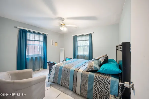 a bedroom with a bed and couch