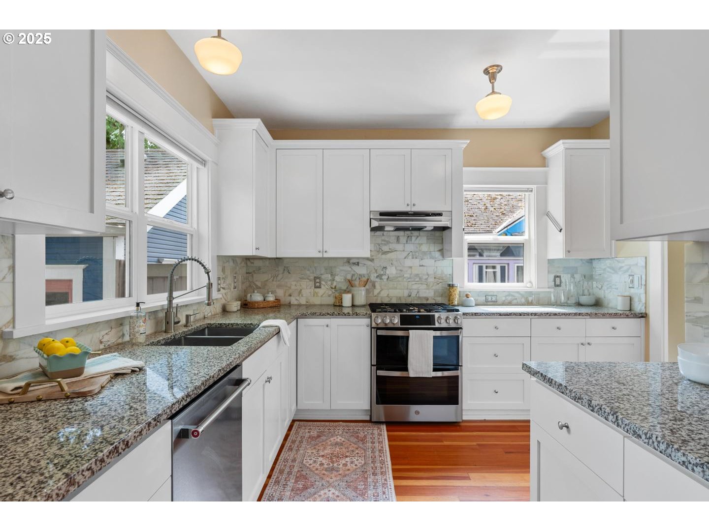1626 Southeast 35th Avenue Portland, OR 97214 - Photo 12 of 40 a kitchen with stainless steel appliances granite countertop a sink stove and cabinets
