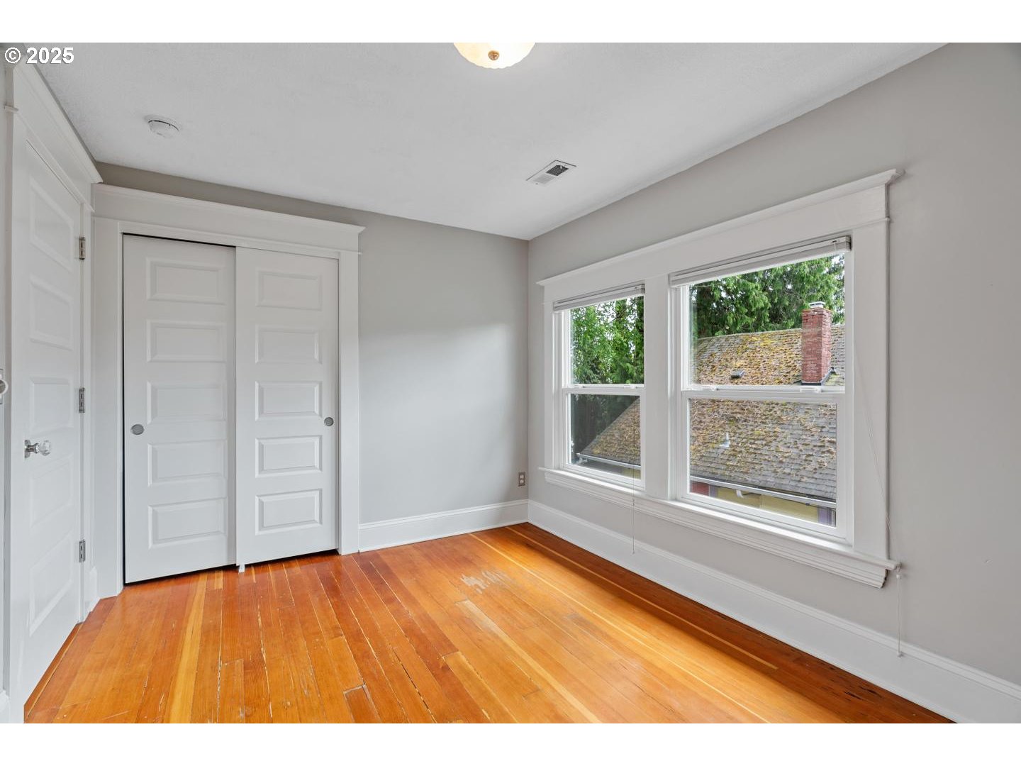 1626 Southeast 35th Avenue Portland, OR 97214 - Photo 25 of 40 a view of an empty room with wooden floor and a window