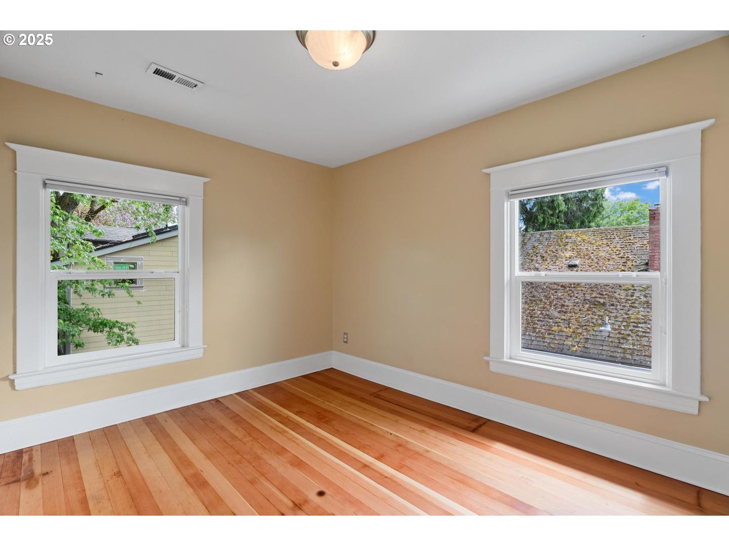 1626 Southeast 35th Avenue Portland, OR 97214 - Photo 26 of 40 a view of an empty room with wooden floor and a window