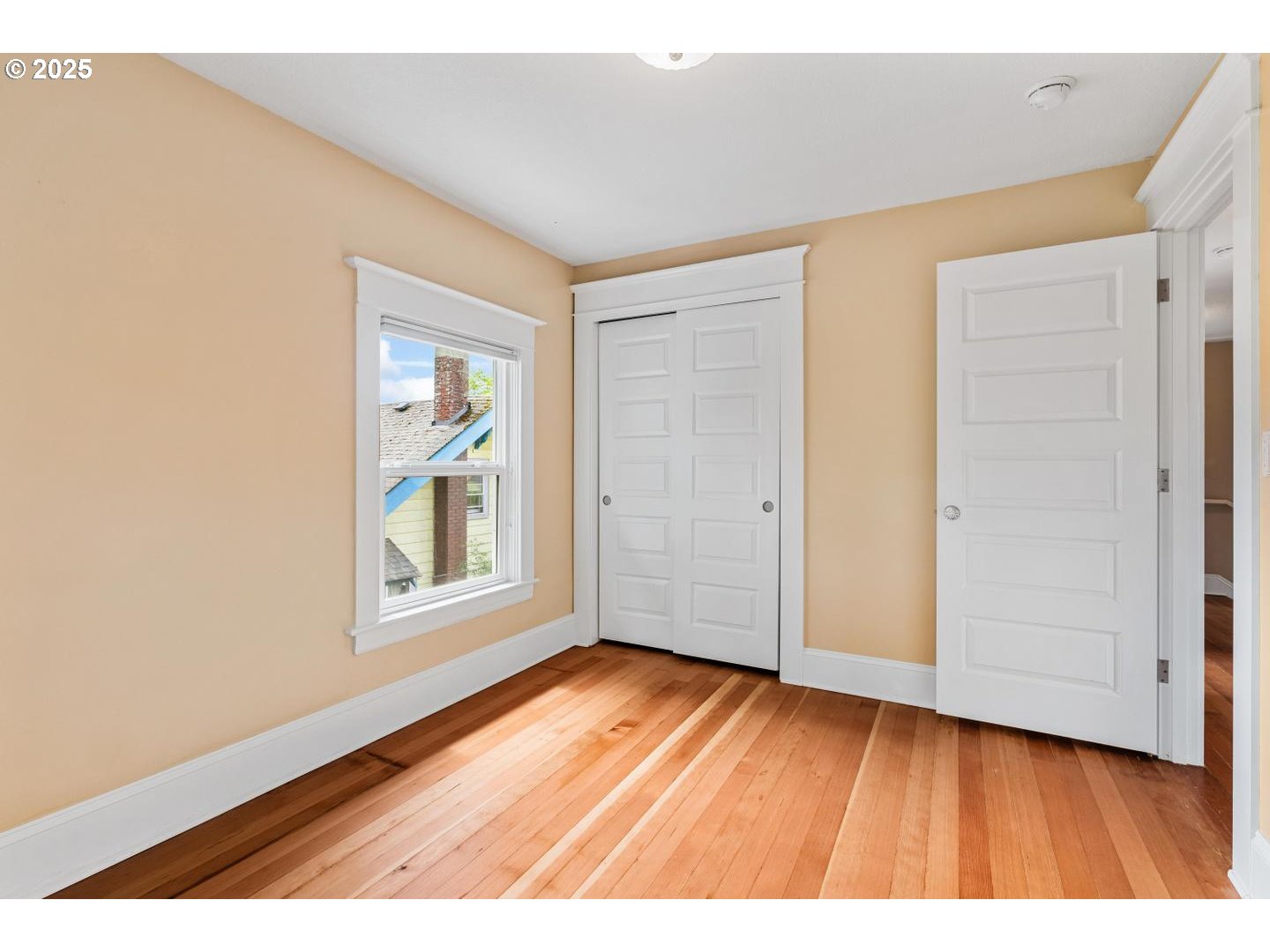 1626 Southeast 35th Avenue Portland, OR 97214 - Photo 27 of 40 an empty room with wooden floor and windows