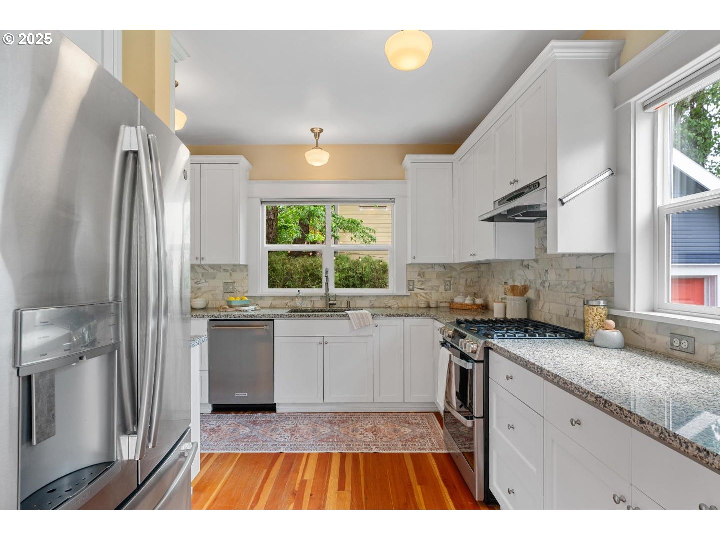 1626 Southeast 35th Avenue Portland, OR 97214 - Photo 10 of 40 a kitchen with a sink a stove cabinets and a wooden floor