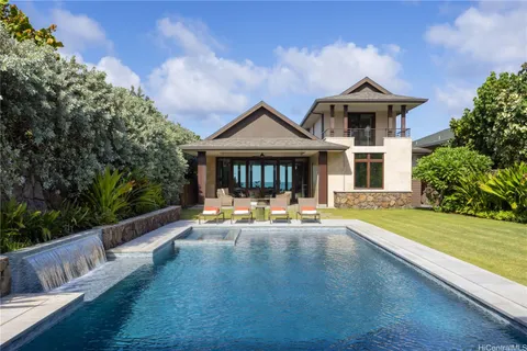 a front view of a house with swimming pool having outdoor seating