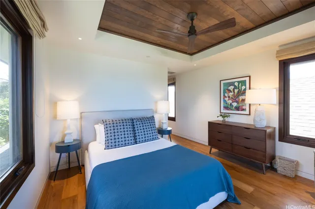 a bedroom with a bed and a dresser next to a window