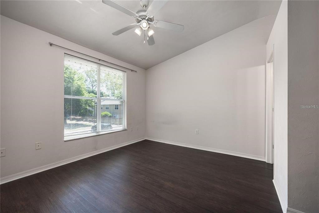 3510 Southwest 30th Way, Unit 158 Gainesville, FL 32608 - Photo 24 of 27 a view of empty room with wooden floor and fan