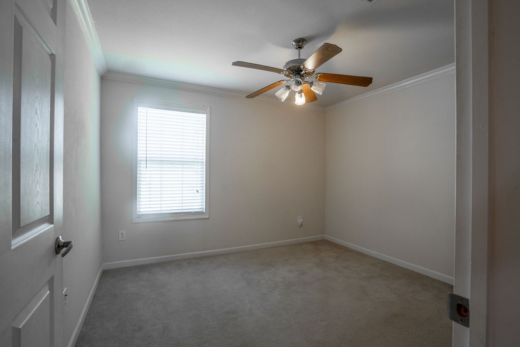 635 8th Street Dickinson, TX 77539 - Photo 7 of 12 an empty room with windows and fan