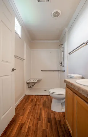 a bathroom with a toilet and a shower