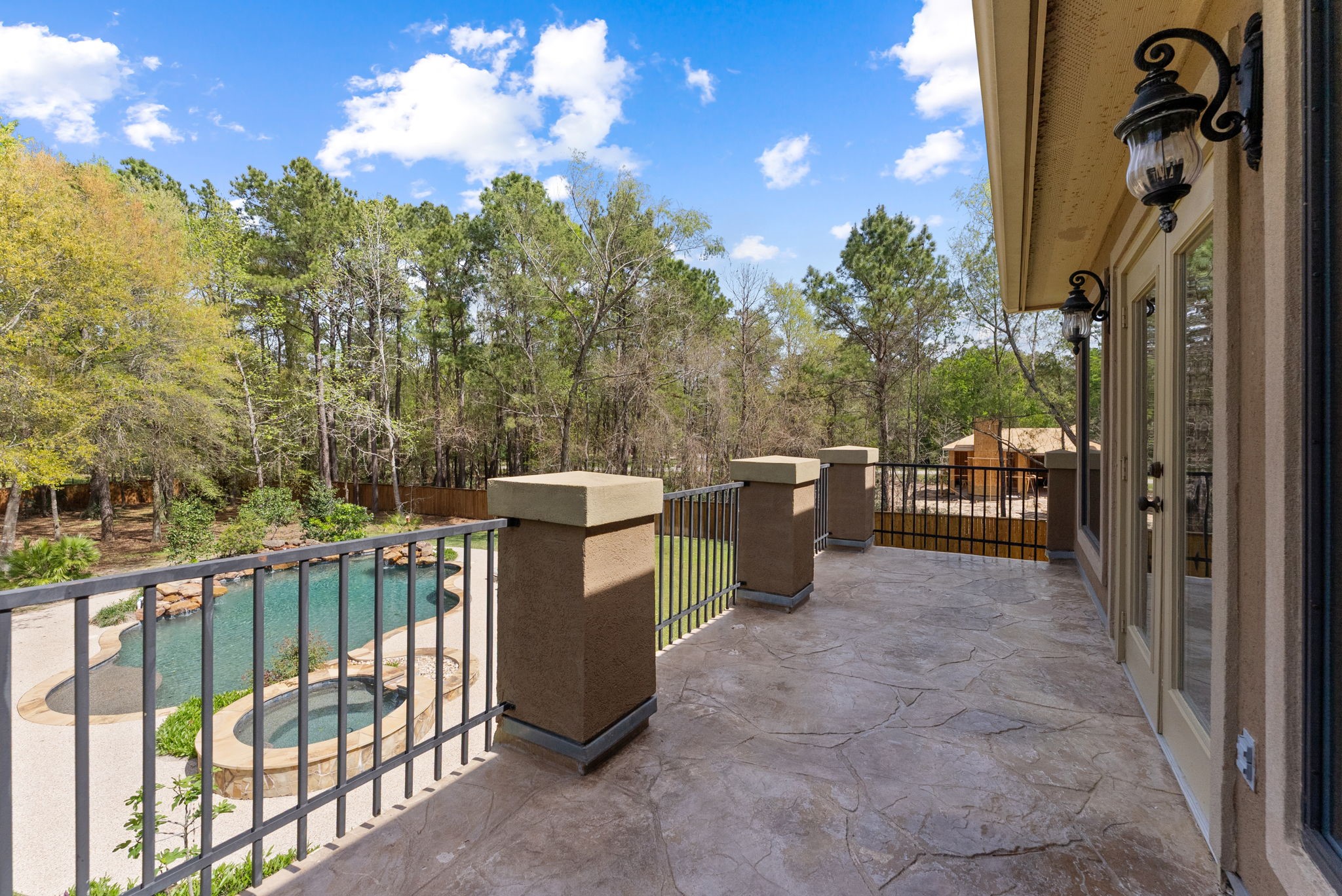 3907 Rayford Road Spring, TX 77386 - Photo 29 of 38 An expansive balcony with stamped concrete decking provides the perfect place to relax and take in views of the exceptional backyard and pool below.