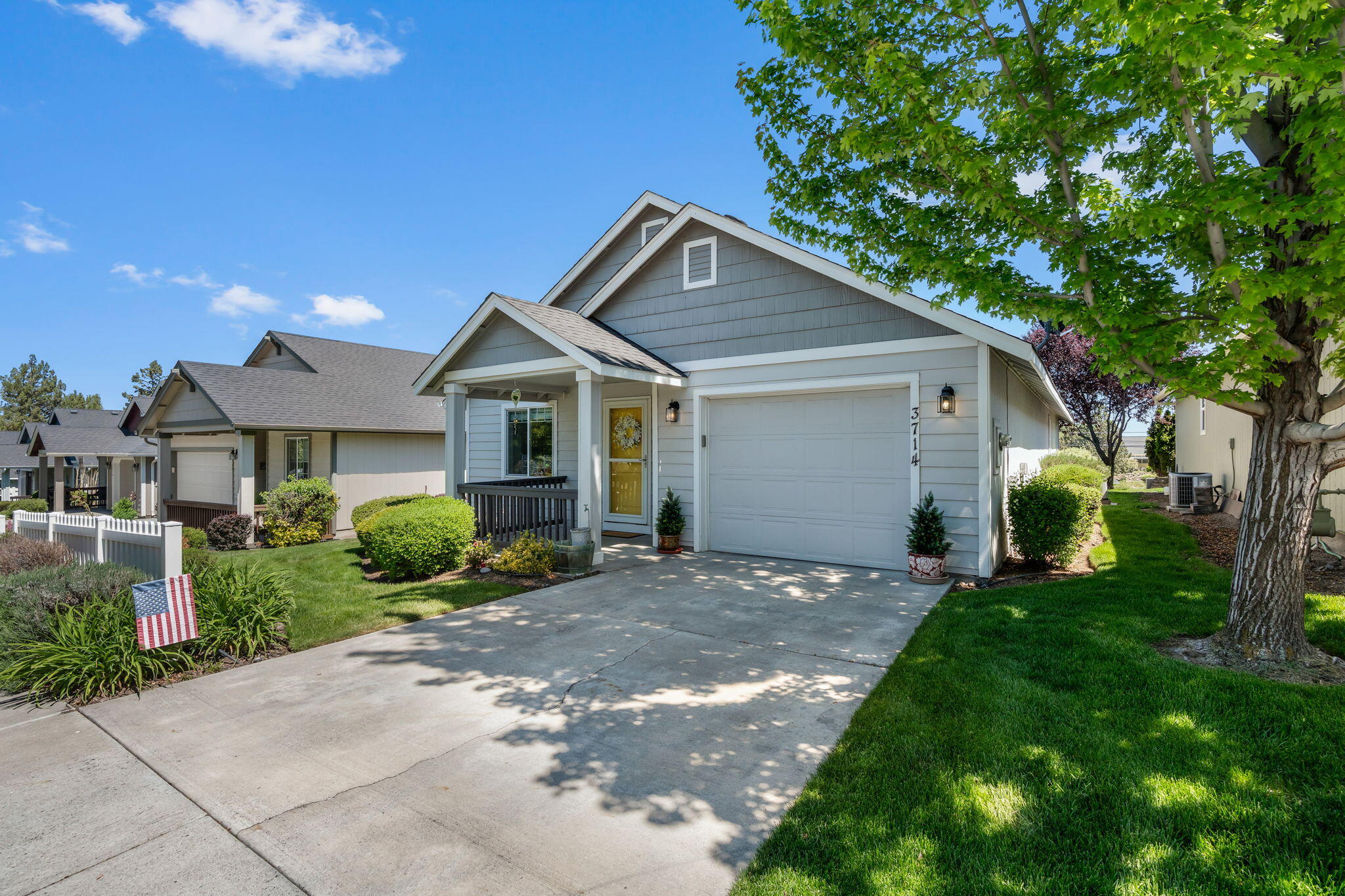 3714 Southwest 29th Street Redmond, OR 97756 - Photo 2 of 21 a front view of a house with a yard and garage