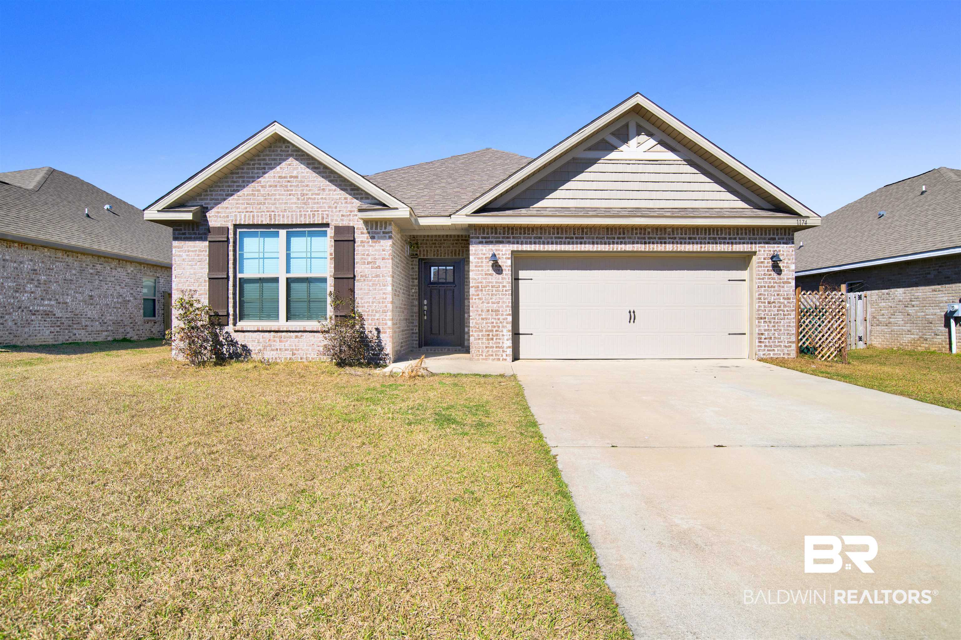 1174 Pheasant Circle Foley, AL 36535 - Photo 2 of 29 View of front facade with concrete driveway, an attached garage, and brick siding