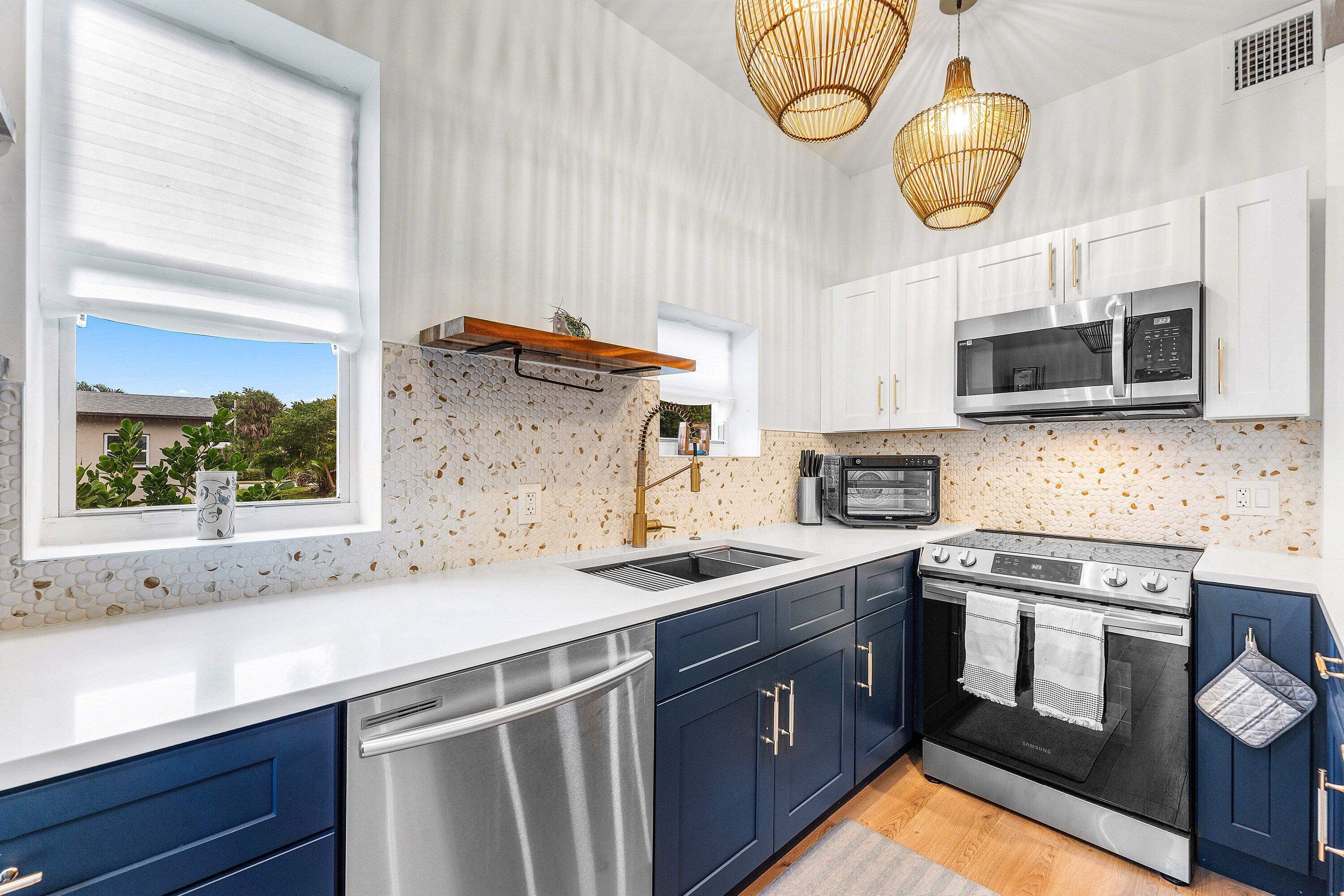 709 Southwest 9th Court Delray Beach, FL 33444 - Photo 11 of 32 a kitchen that has a sink and a stove