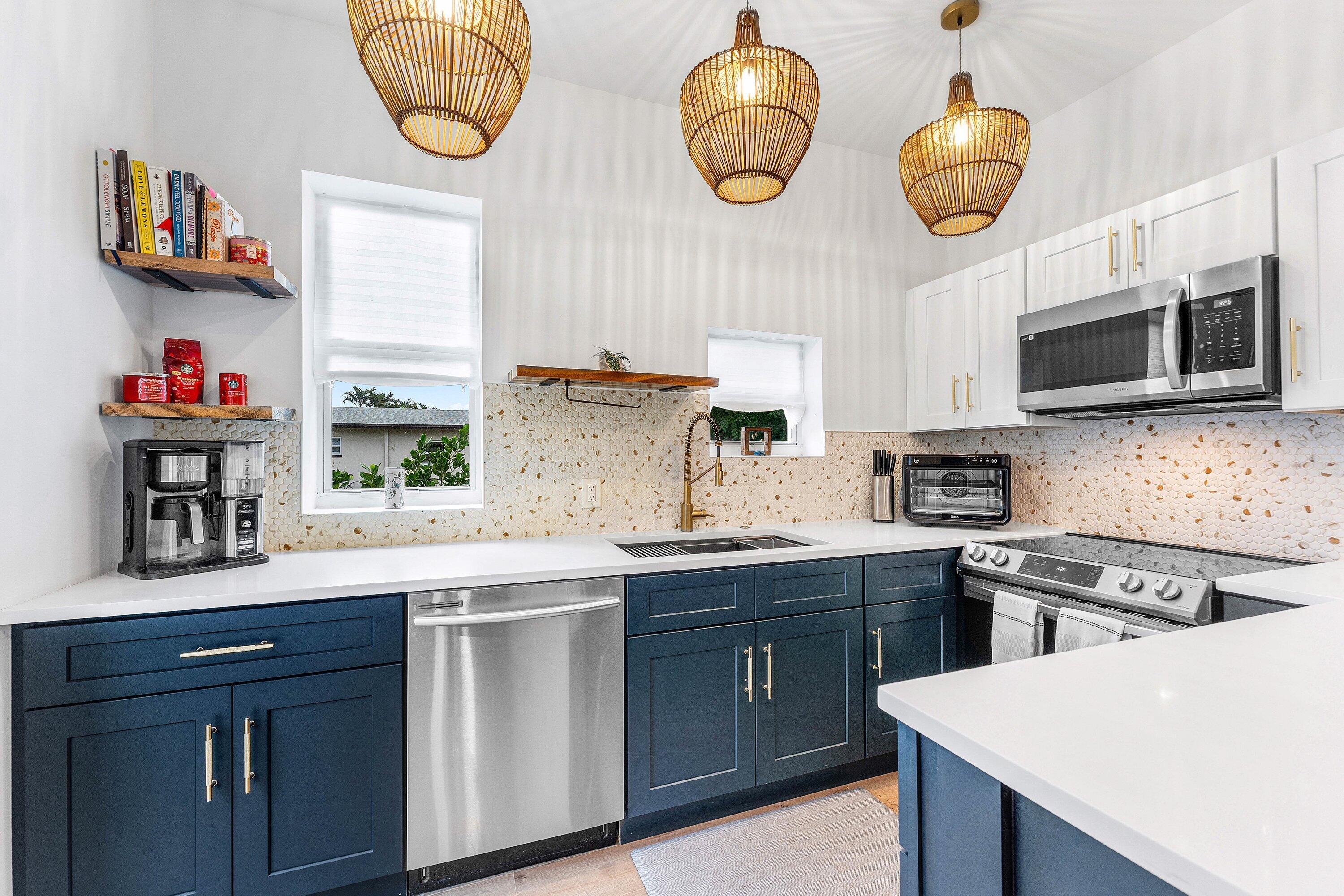 709 Southwest 9th Court Delray Beach, FL 33444 - Photo 14 of 32 a kitchen with stainless steel appliances a stove a sink and a microwave