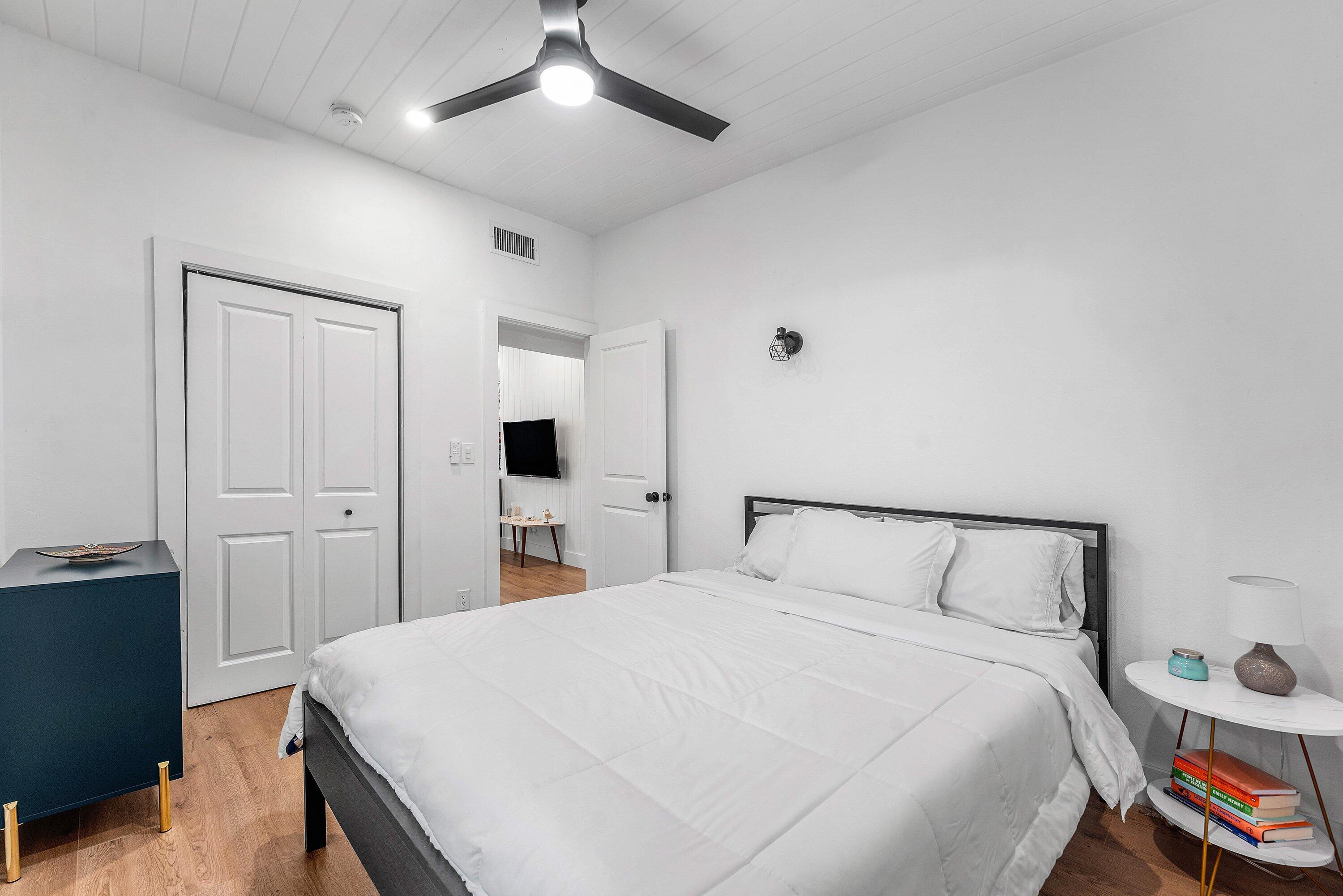 709 Southwest 9th Court Delray Beach, FL 33444 - Photo 16 of 32 a bedroom with a bed and a chandelier