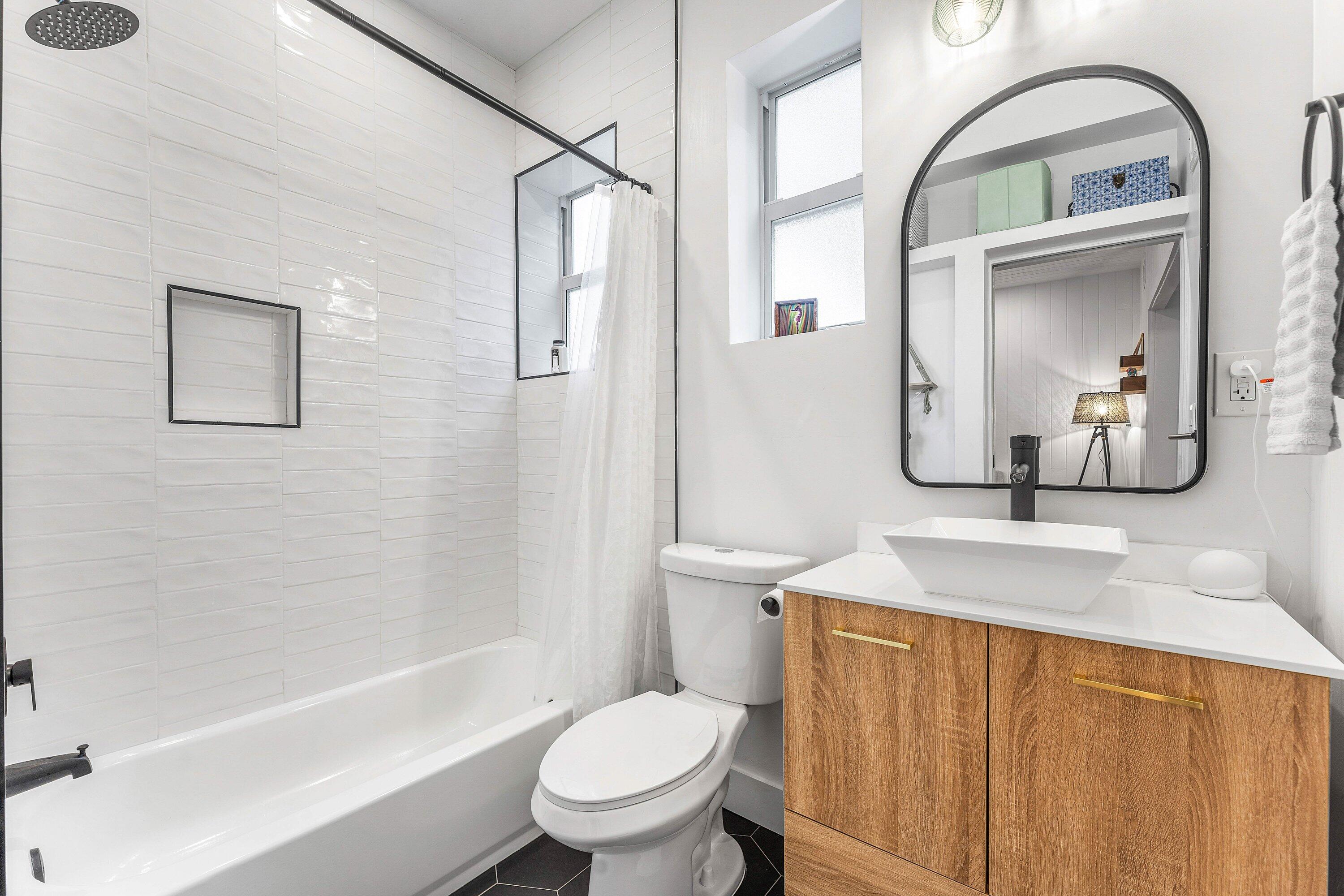 709 Southwest 9th Court Delray Beach, FL 33444 - Photo 22 of 32 a bathroom with a toilet sink and mirror
