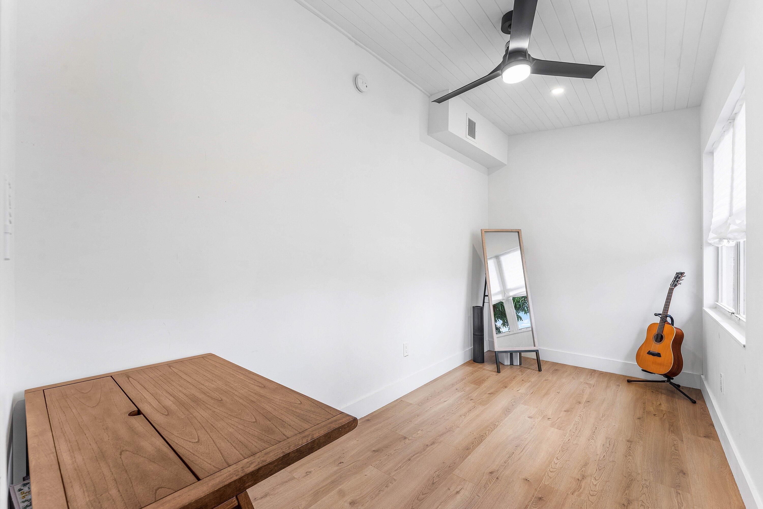 709 Southwest 9th Court Delray Beach, FL 33444 - Photo 23 of 32 a view of a room with wooden floor and gym equipment