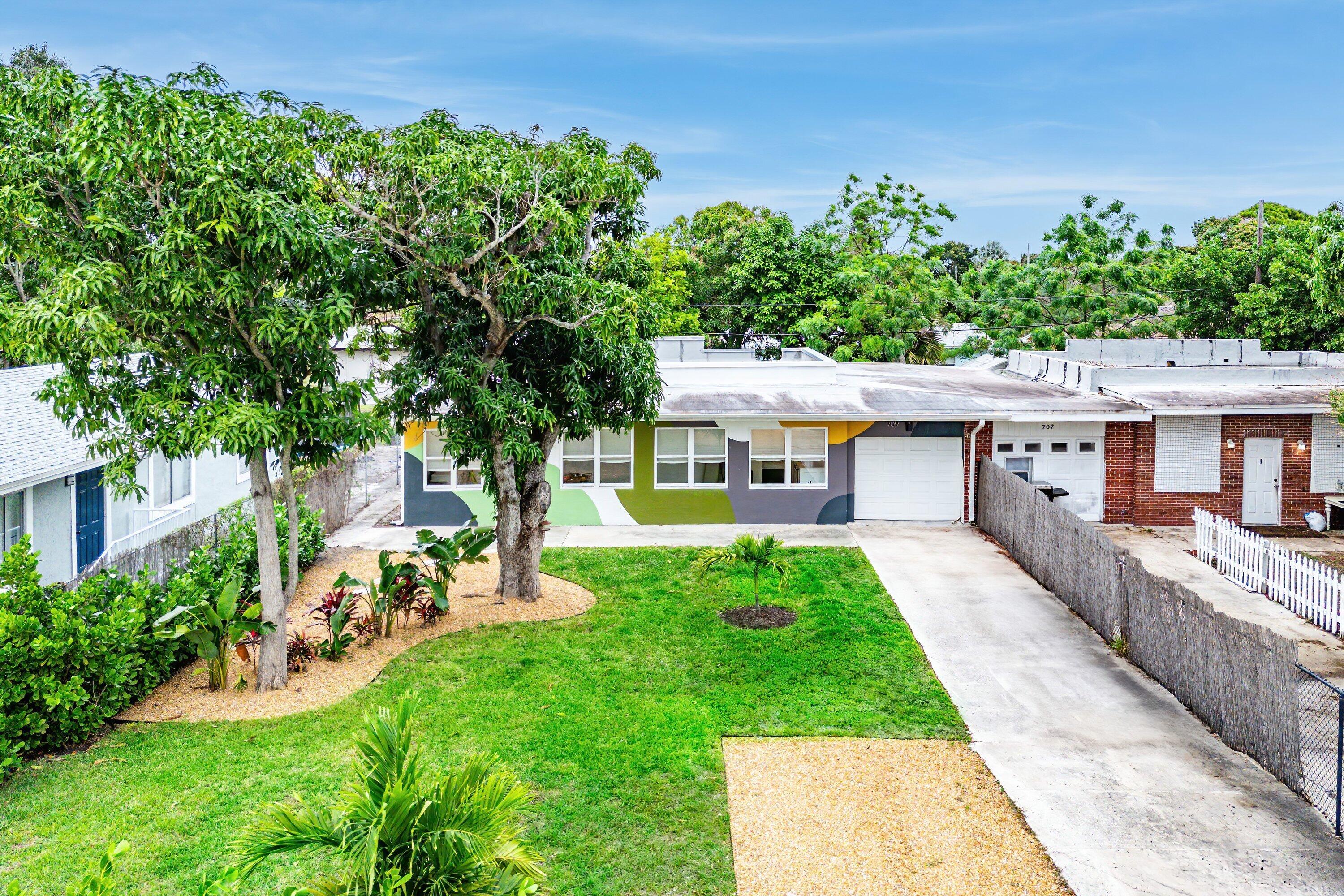 709 Southwest 9th Court Delray Beach, FL 33444 - Photo 28 of 32 a view of house with garden and a sitting area