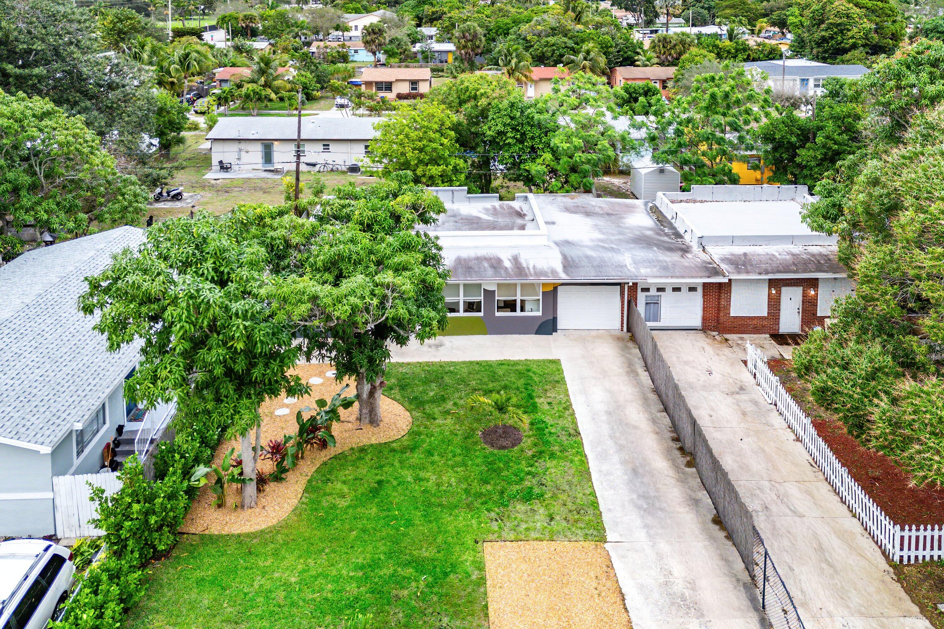 709 Southwest 9th Court Delray Beach, FL 33444 - Photo 30 of 32 an aerial view of a house with a garden and trees