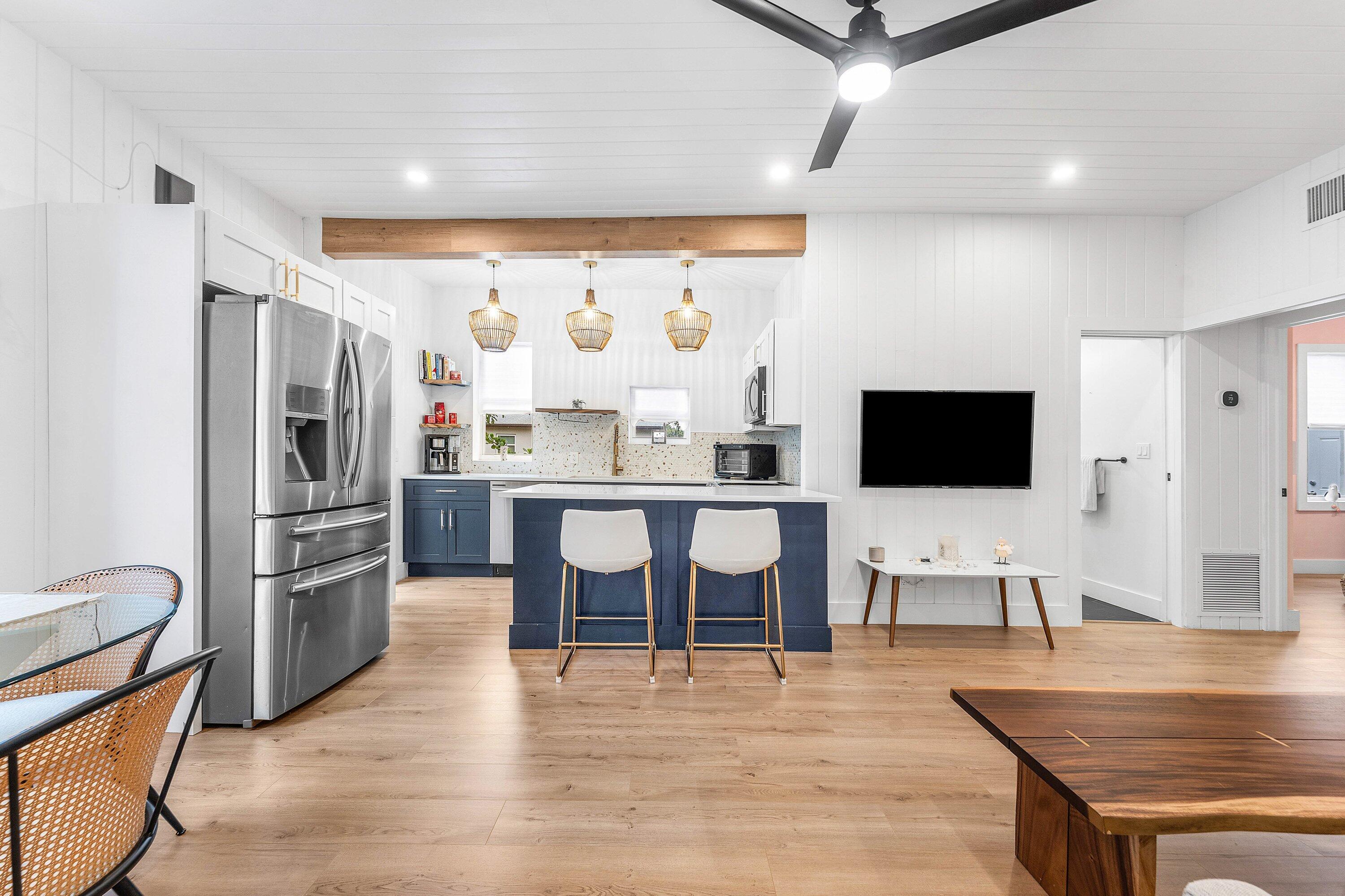 709 Southwest 9th Court Delray Beach, FL 33444 - Photo 8 of 32 a living room with stainless steel appliances furniture and a flat screen tv