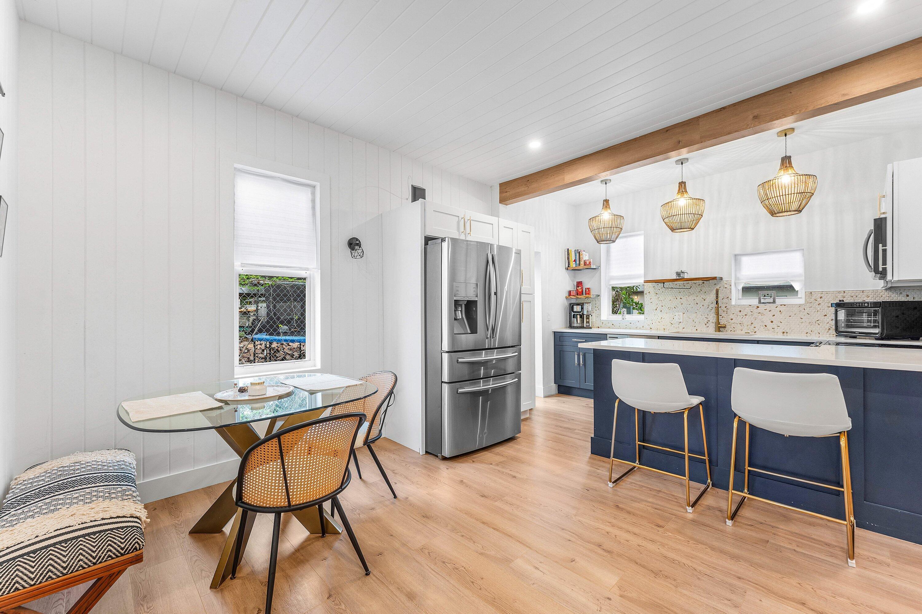 709 Southwest 9th Court Delray Beach, FL 33444 - Photo 9 of 32 a kitchen with a table and chairs in it