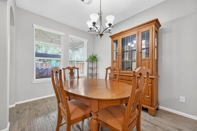 a living room with furniture a dining table and a piano table