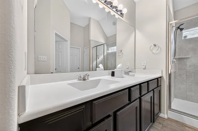 a bathroom with a double vanity sink and mirror