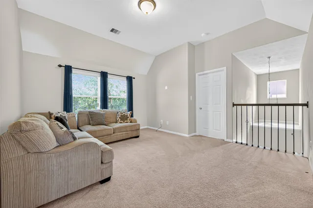 a hall way with wooden floor and staircase