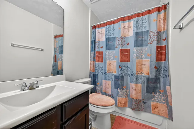 a bathroom with a sink a toilet and a bathtub