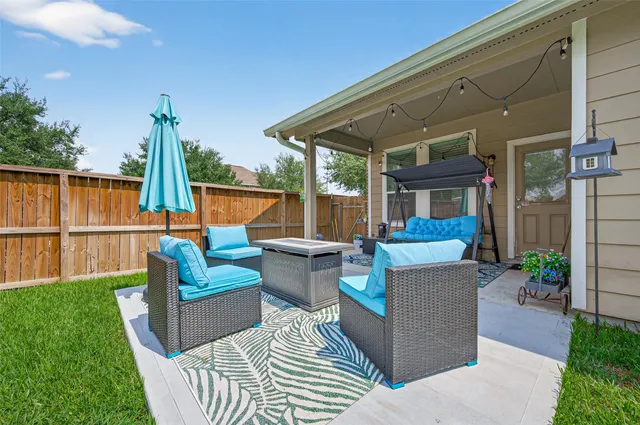 a view of a house with backyard porch and sitting area
