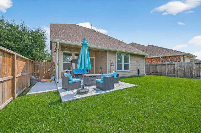 a view of a backyard with table and chairs