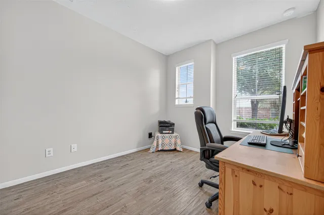 a view of a workspace with furniture and a window