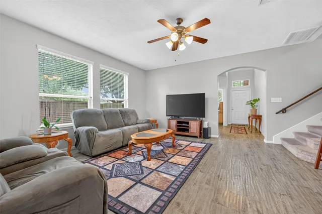 a living room with furniture and a flat screen tv