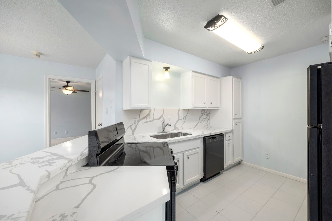 12755 Mill Ridge Drive, Unit 301 Cypress, TX 77429 - Photo 12 of 24 a kitchen with a sink appliances and cabinets