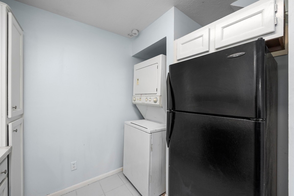 12755 Mill Ridge Drive, Unit 301 Cypress, TX 77429 - Photo 13 of 24 a white refrigerator freezer and a stove sitting inside of a kitchen