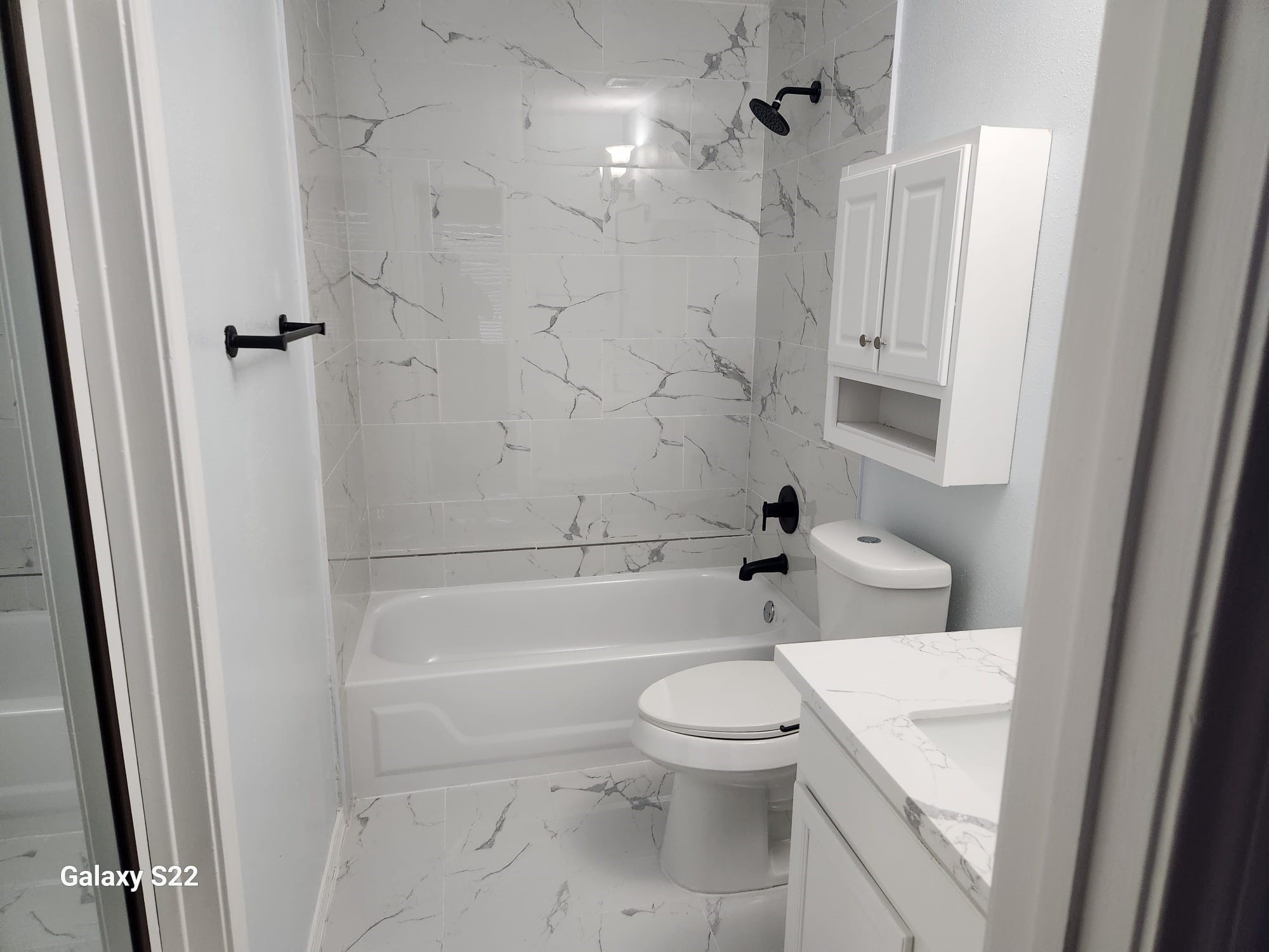 12755 Mill Ridge Drive, Unit 301 Cypress, TX 77429 - Photo 16 of 24 a white toilet sitting next to a bath tub