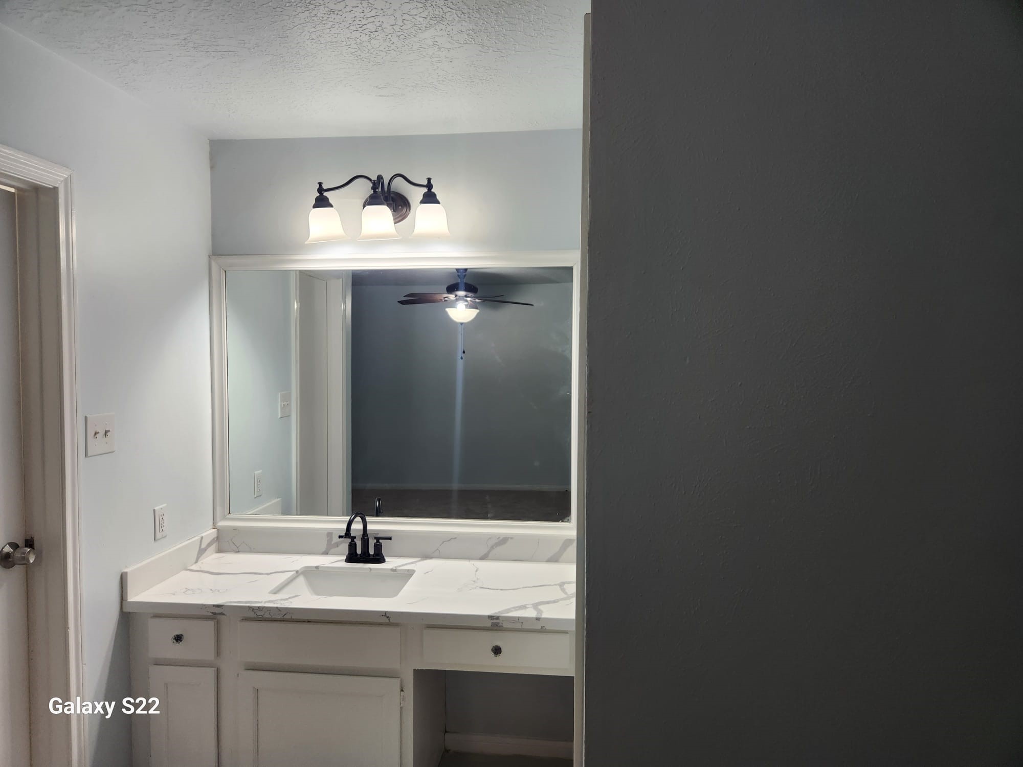 12755 Mill Ridge Drive, Unit 301 Cypress, TX 77429 - Photo 21 of 24 a bathroom with a sink and a mirror