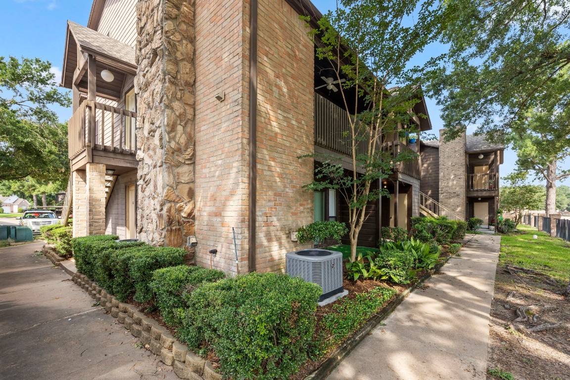 12755 Mill Ridge Drive, Unit 301 Cypress, TX 77429 - Photo 24 of 24 a view of a building with a yard