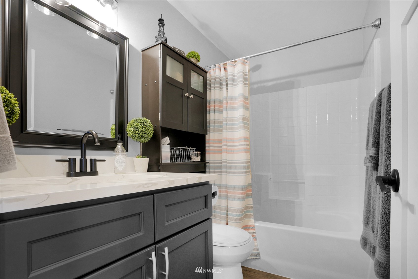 19303 Crown Ridge Boulevard Arlington, WA 98223 - Photo 18 of 30 a bathroom with a sink a toilet a mirror and shower