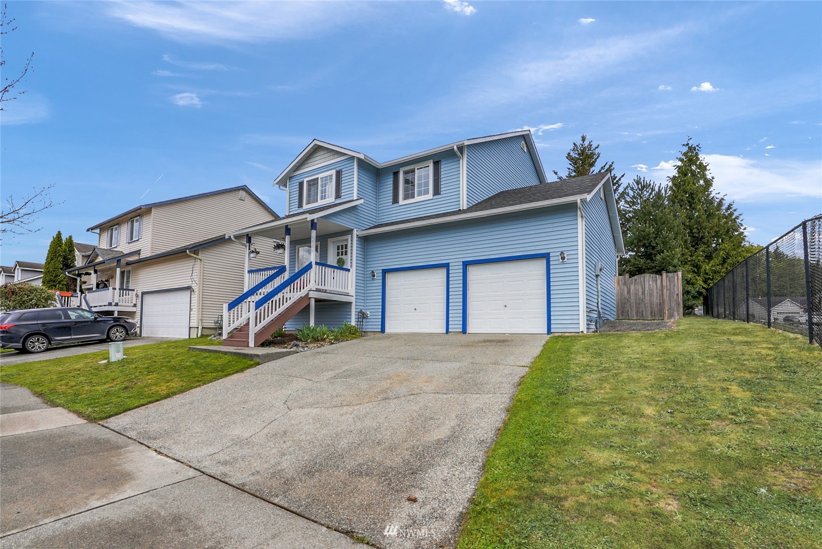 19303 Crown Ridge Boulevard Arlington, WA 98223 - Photo 2 of 30 a front view of a house with a yard and garage