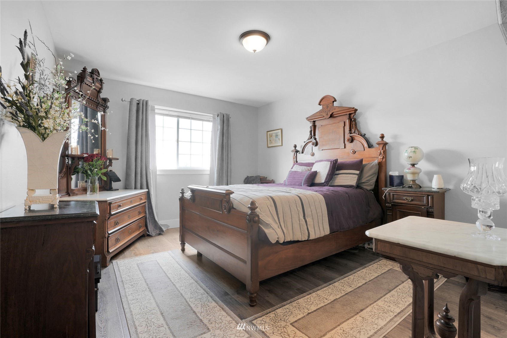 19303 Crown Ridge Boulevard Arlington, WA 98223 - Photo 21 of 30 a bedroom with a bed and a potted plant