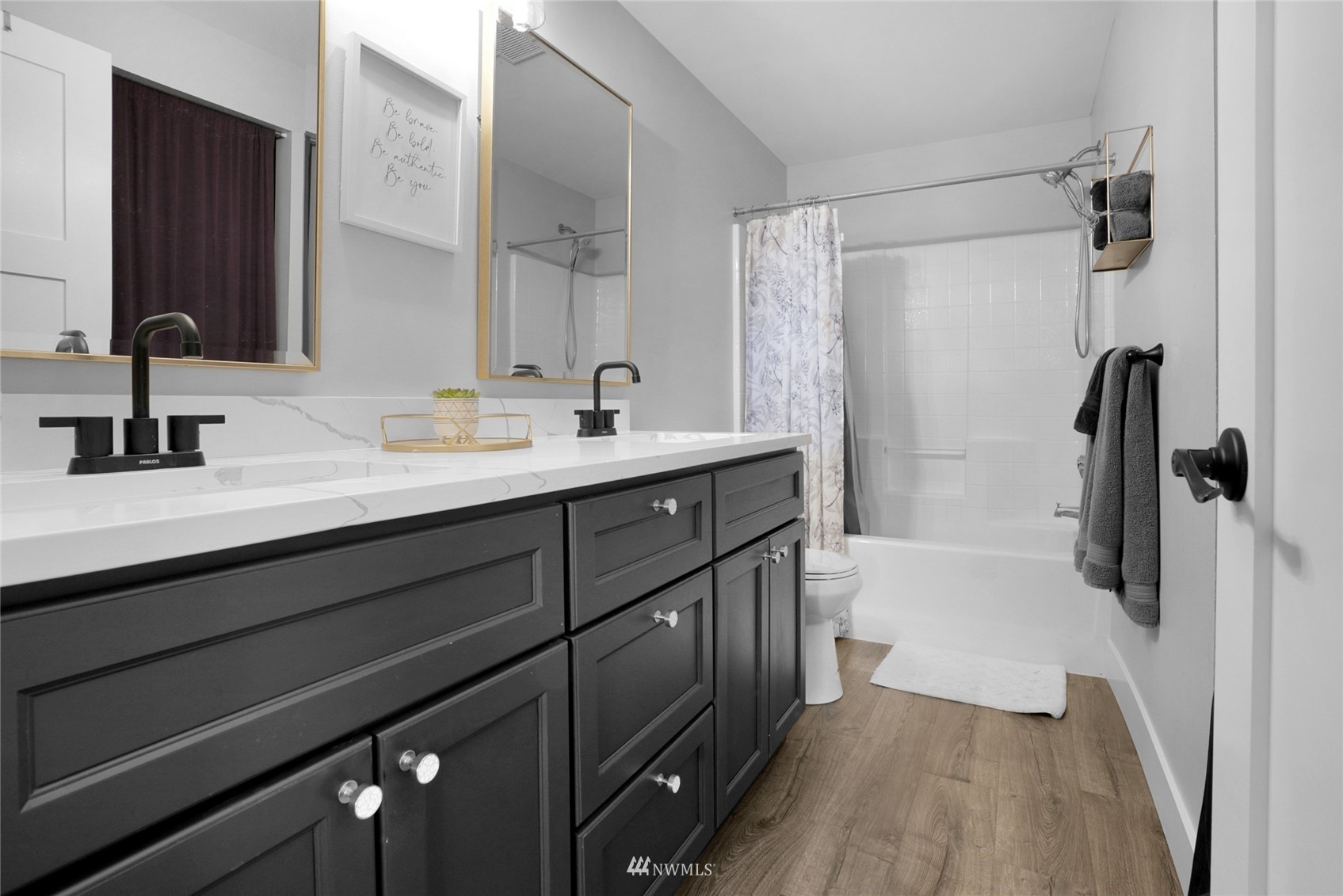 19303 Crown Ridge Boulevard Arlington, WA 98223 - Photo 23 of 30 a bathroom with a double vanity sink a mirror and a bathtub