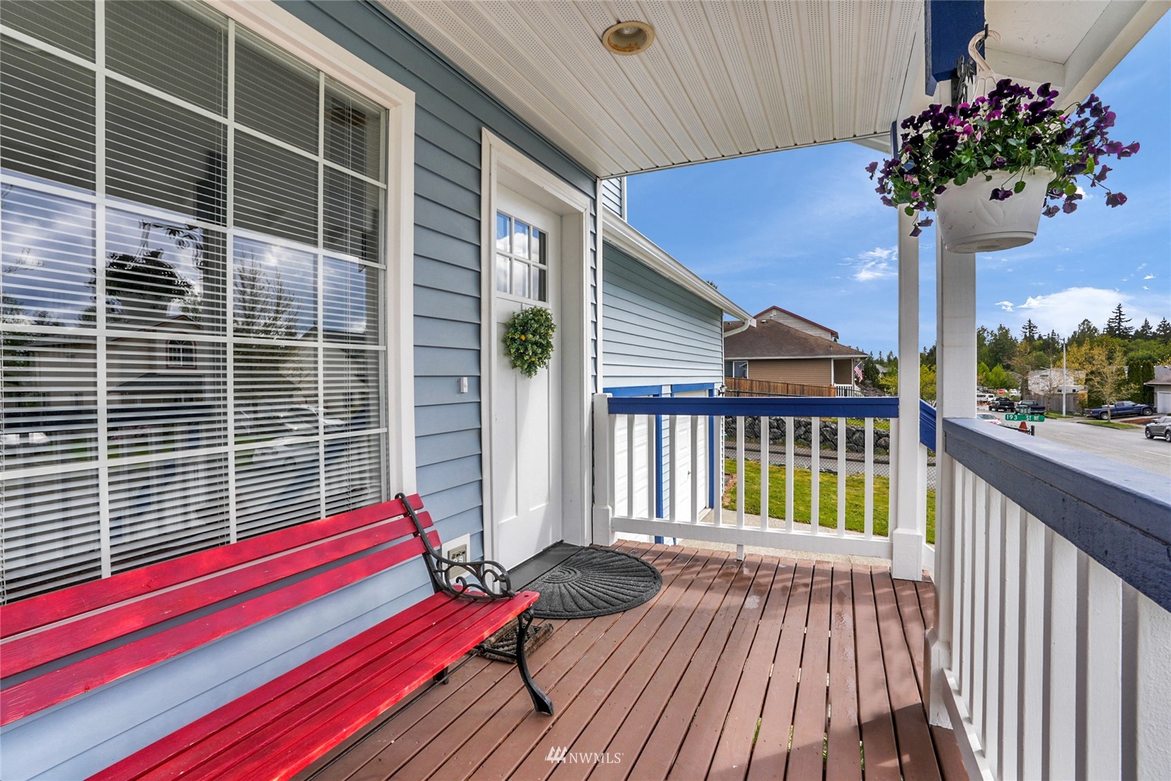 19303 Crown Ridge Boulevard Arlington, WA 98223 - Photo 5 of 30 a view of a balcony with a potted plant and wooden floor