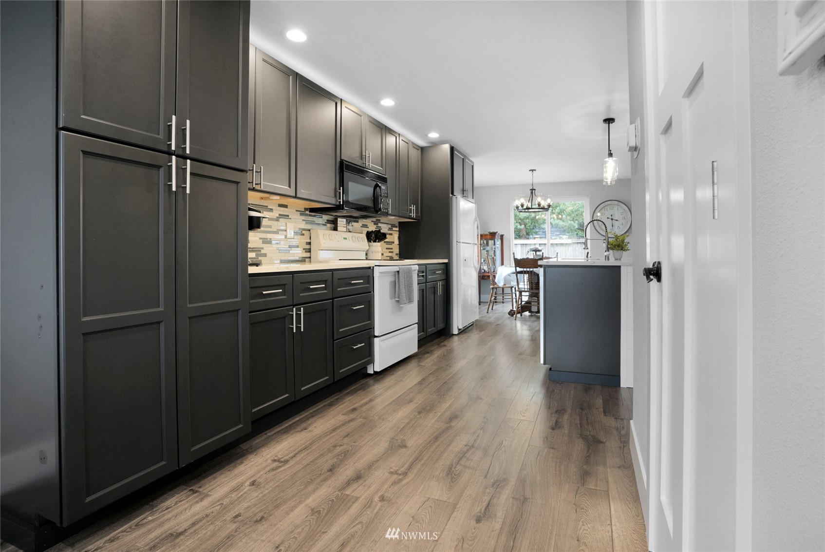 19303 Crown Ridge Boulevard Arlington, WA 98223 - Photo 9 of 30 a kitchen with stainless steel appliances a refrigerator and wooden cabinets